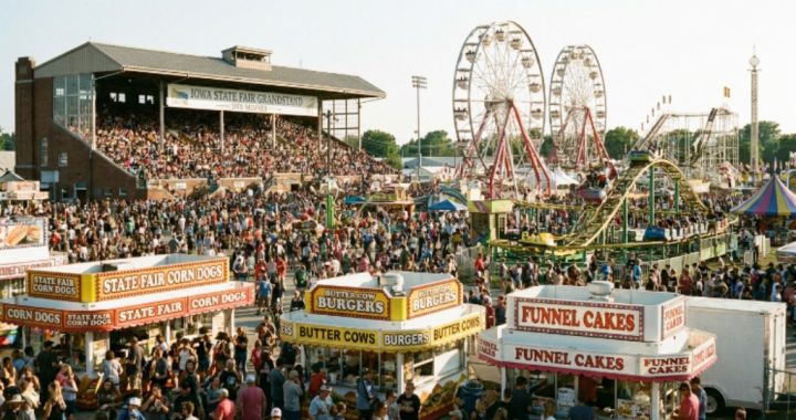 Crowds enjoying rides and food at the Iowa State Fair grandstand in Des Moines