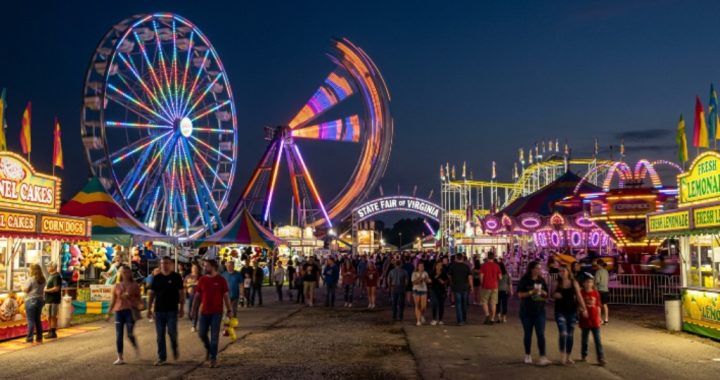 Carnival rides lit up at the State Fair of Virginia midway at night