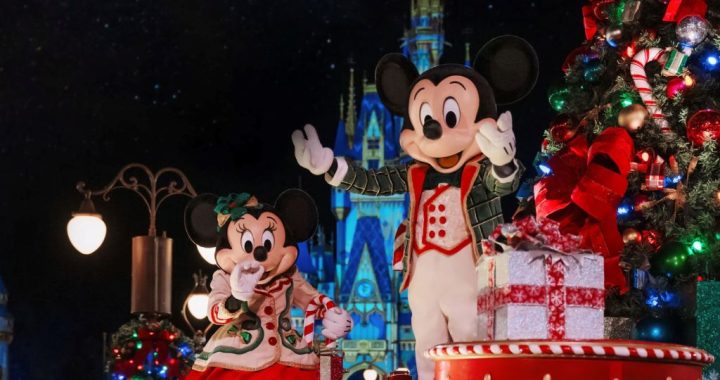 Mickey and Minnie Mouse waving from a festive float during Mickey's Once Upon a Christmastime Parade at Magic Kingdom